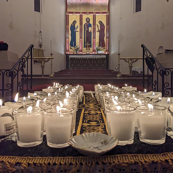 Tealight candles with the altar in the background.