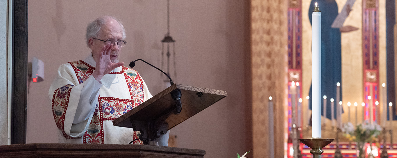 Fr Jim Beall preaching a sermon from the pulpit