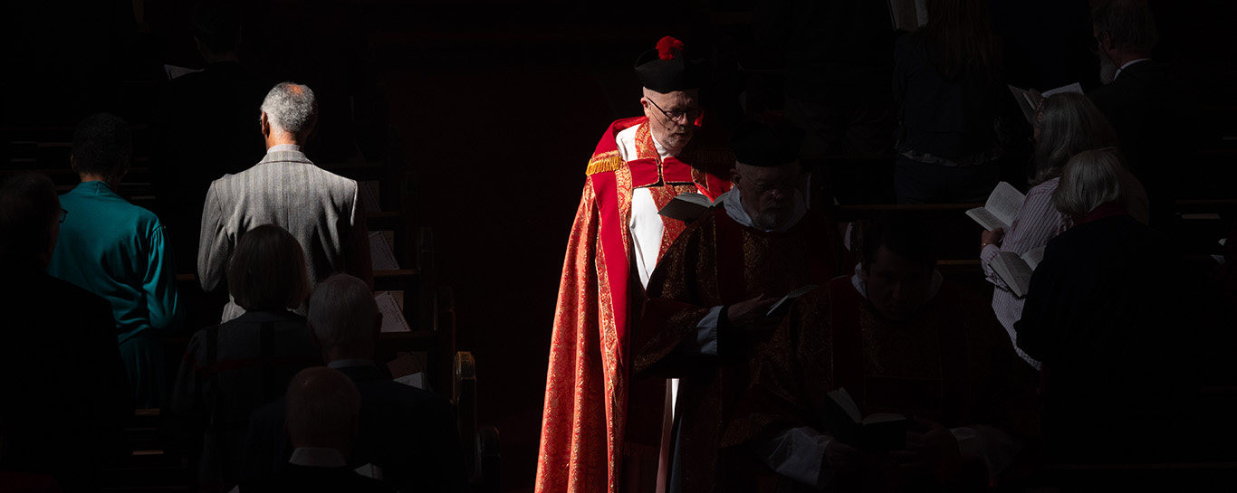 Fr Jim Beall in procession wearing red vestments
