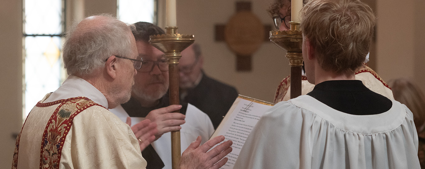 Fr Jim Beall reading the gospel in the nave