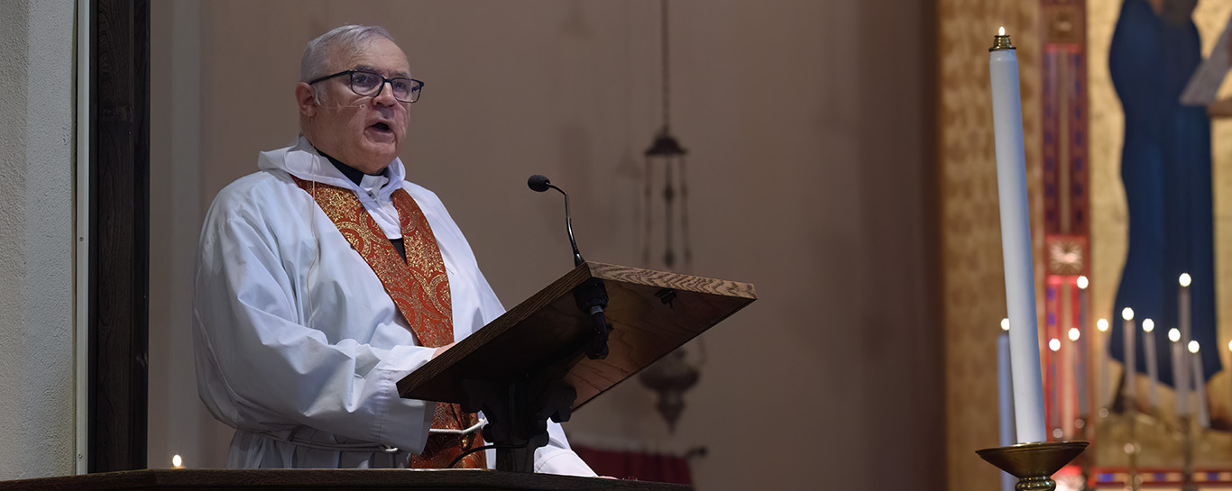 Fr Young preaching from the pulpit