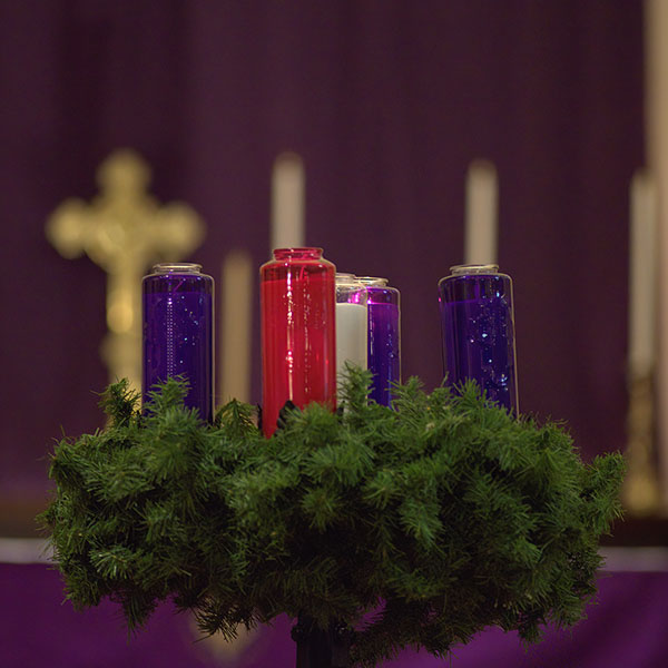 Advent candles with the altar in the background. 