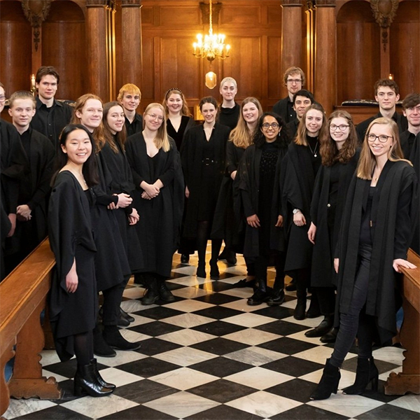 Members of the choir in black robes in Pembroke College Chapel.