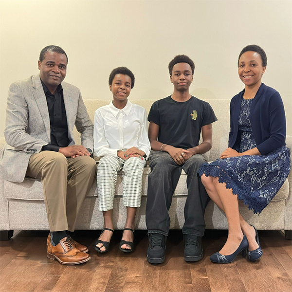 Fr Kwari's family sitting on a couch