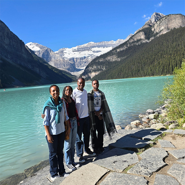 Fr Kwari's family beside a lake in the Rockies