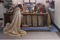 Fr Kwari genuflecting at the crèche.