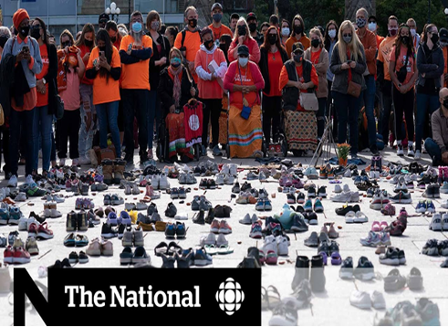 People gathered in front of many pairs of shoes.