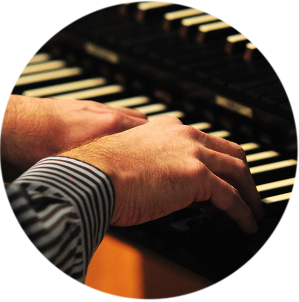 Close up of Wesley Warren's hands playing the organ