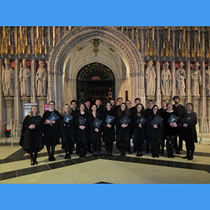 Pembroke choir in front of a cathedral entrance