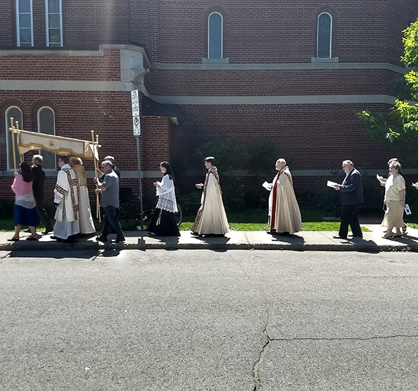 An outdoor procession during the Solemnity of Corpus Christi