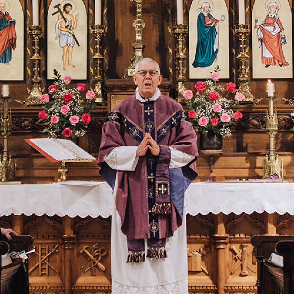 Father Michael Mondloch in purple vestments at the altar