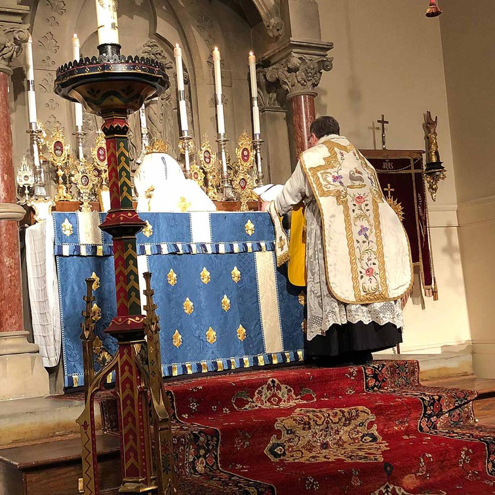 Detail of interior of Church of the Ascension showing a priest at the altar